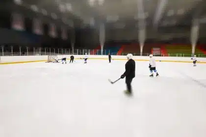 Ishockeyspelare firar mål framför målvakten på isen